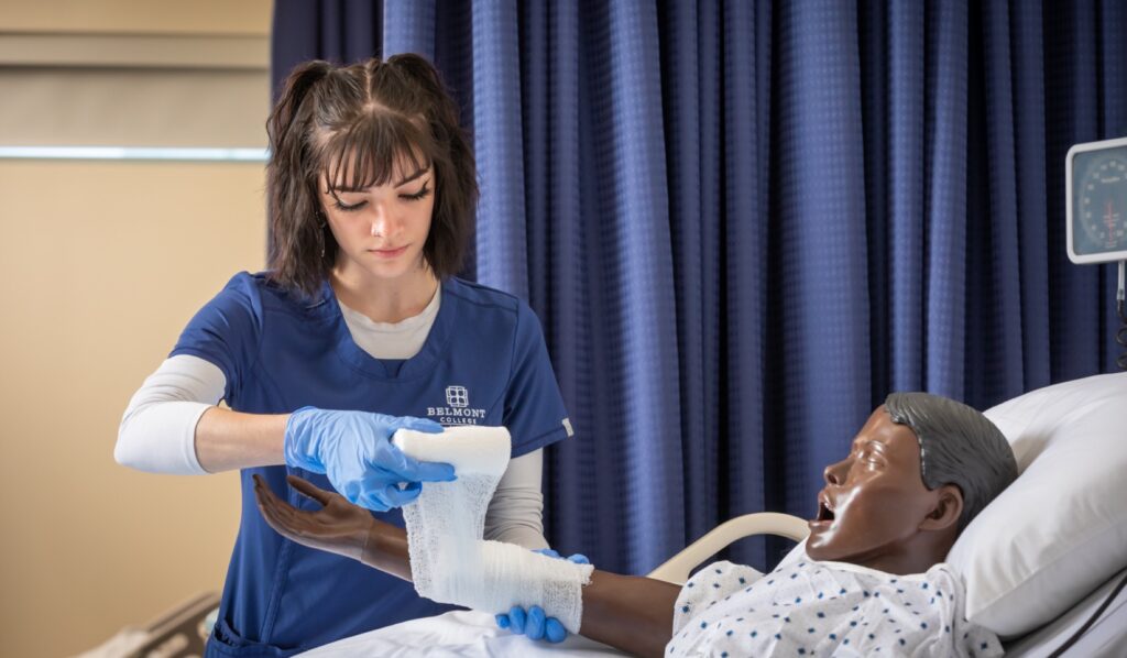 nursing student practicing on dummy