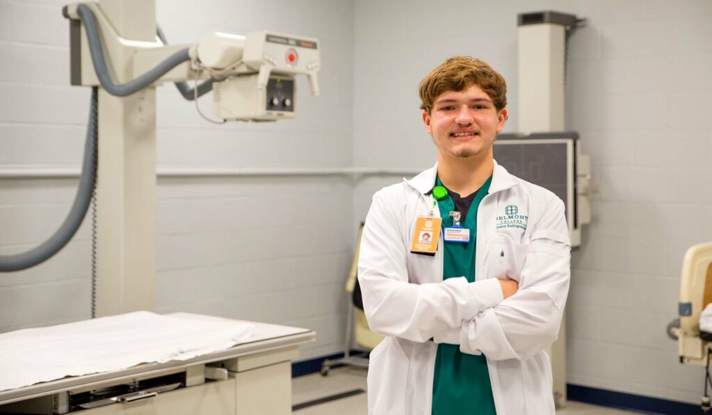 Clayton wearing white coat, in hospital setting