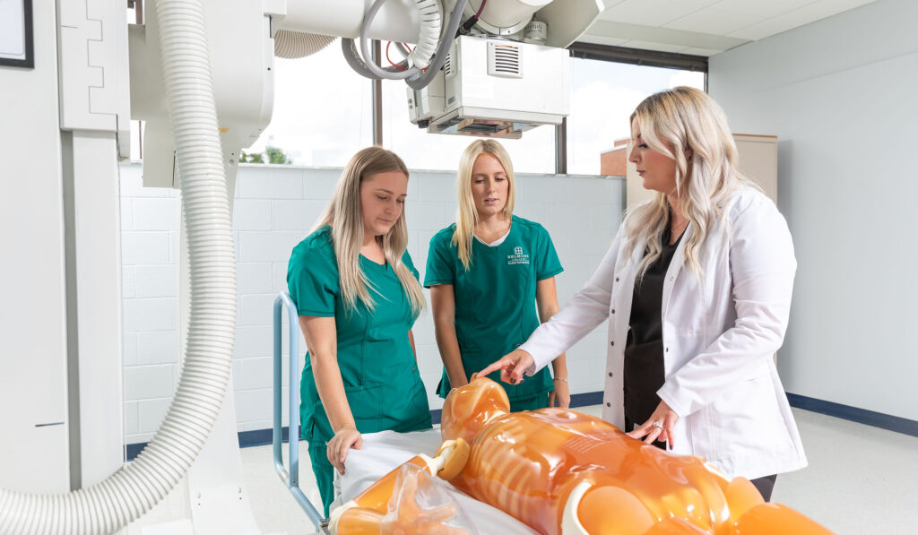 students looking at model of human body