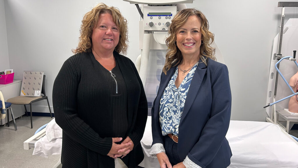 Tammy Corey (left) and Christine Sentz (right) standing in front of medical equipment