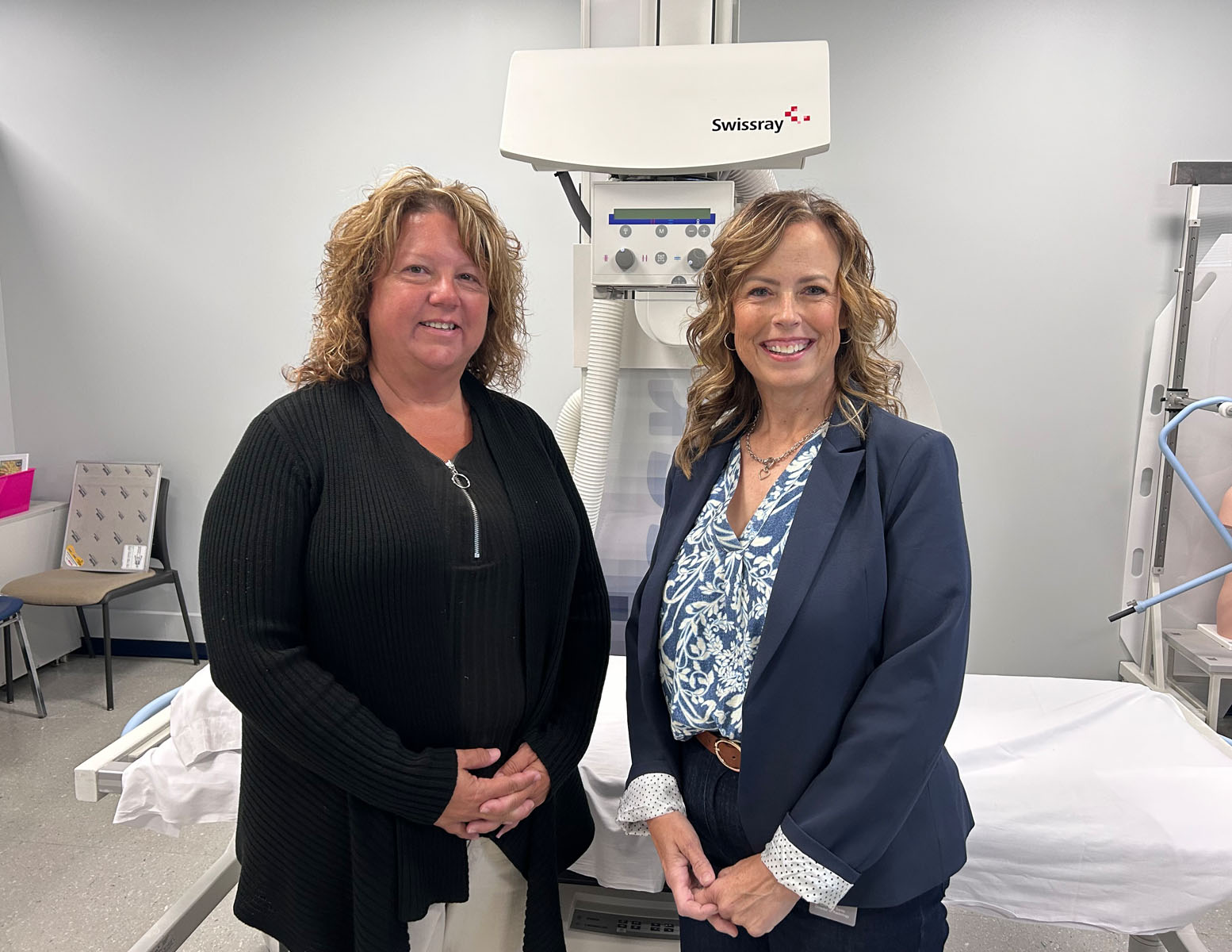 Tammy Corey (left) and Christine Sentz (right) standing in front of medical equipment