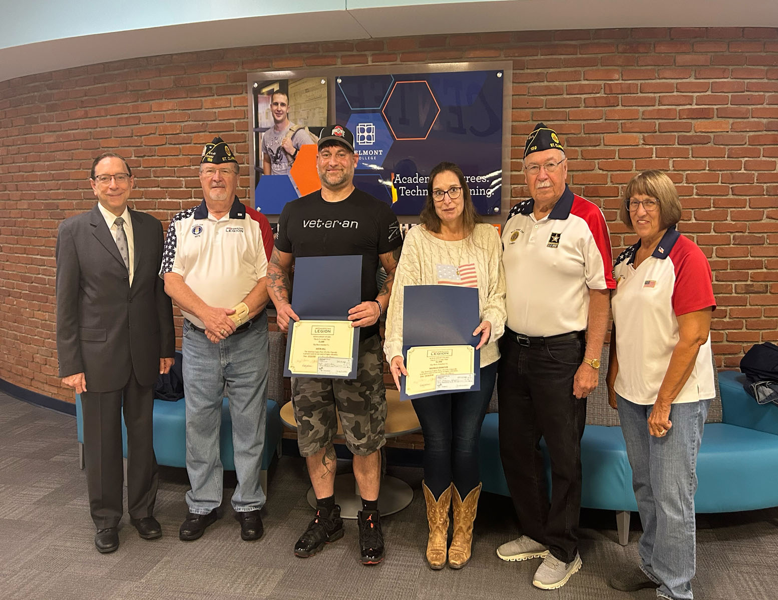 St. Clairsville American Legion Post #159 members present Belmont College students Justin Hall and Michele Johnston with the St. Clairsville American Legion Citizenship Scholarship.